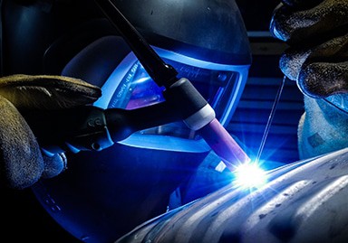 A welder working on a piece of metal.